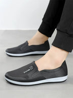 Mustat slip-on tennarit jalassa mustat housut — Helvenza