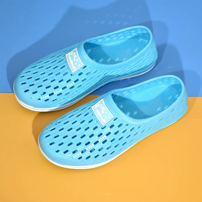 Vaaleansininen reikäkuvioinen slip-on-tossu edestä valkoisella pohjalla — Helvenza